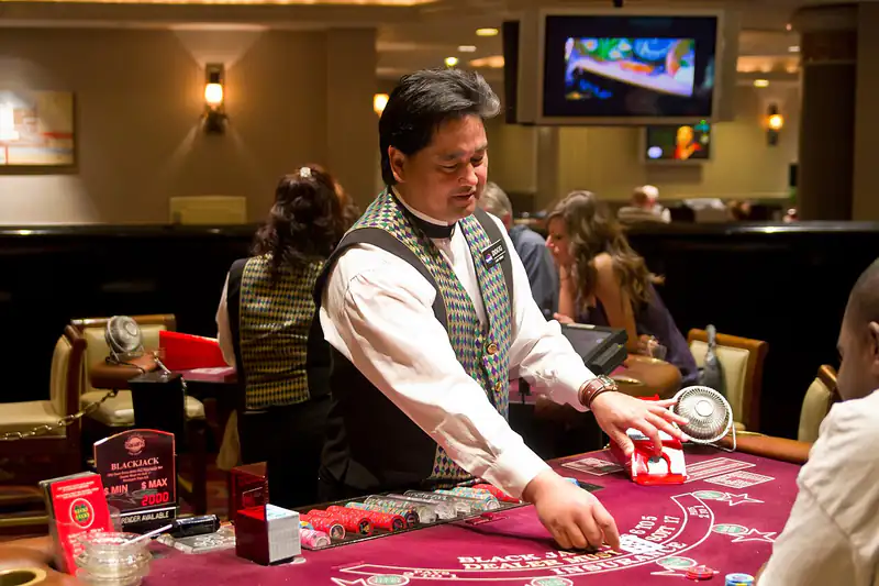Play DEWA90PH live casino — dealer running a card table while guests watch