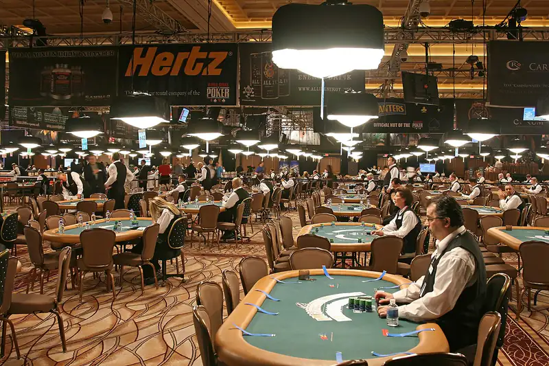 A large poker tournament room full of players