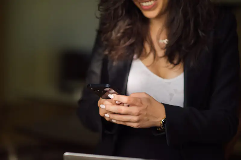 Woman holding a smartphone and tapping the screen